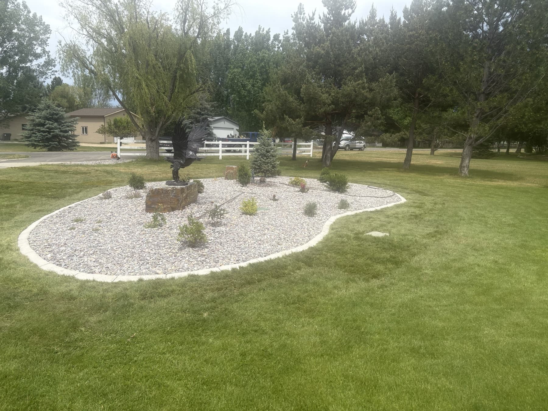 Custom landscape bed with decorative rock and curbing in Florence, MT